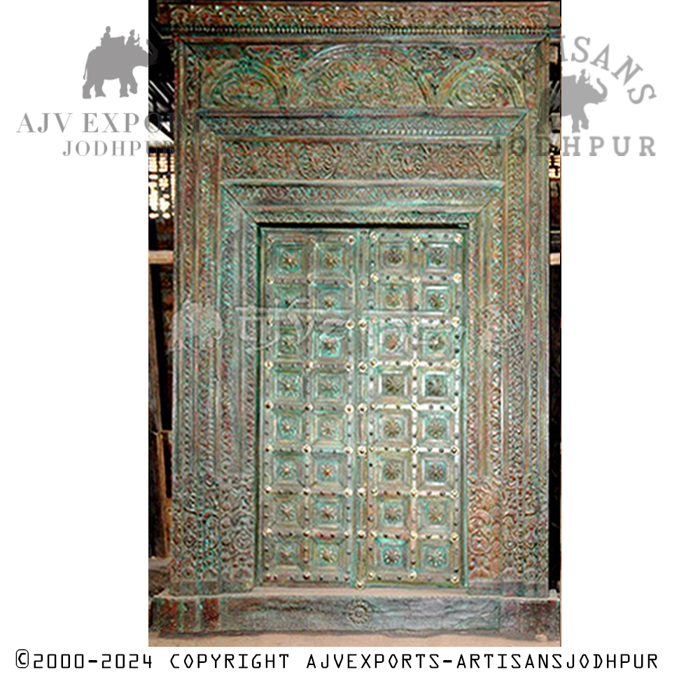 Wooden door with verdigris patina and carvings