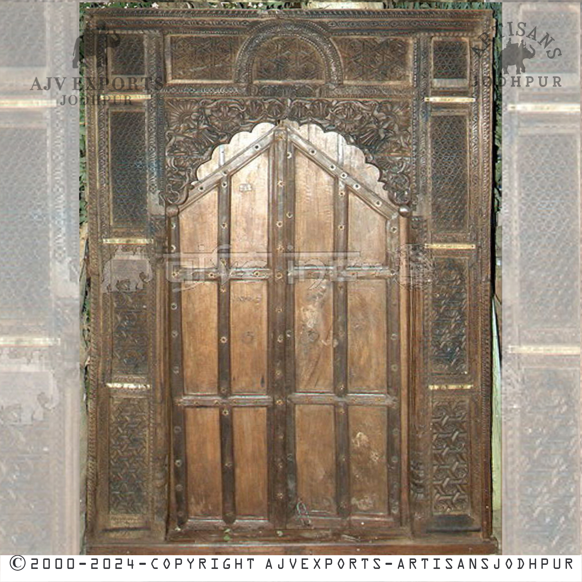 Traditional wooden door with decorative metalwork, offering rustic charm and elegant design for classic interiors.