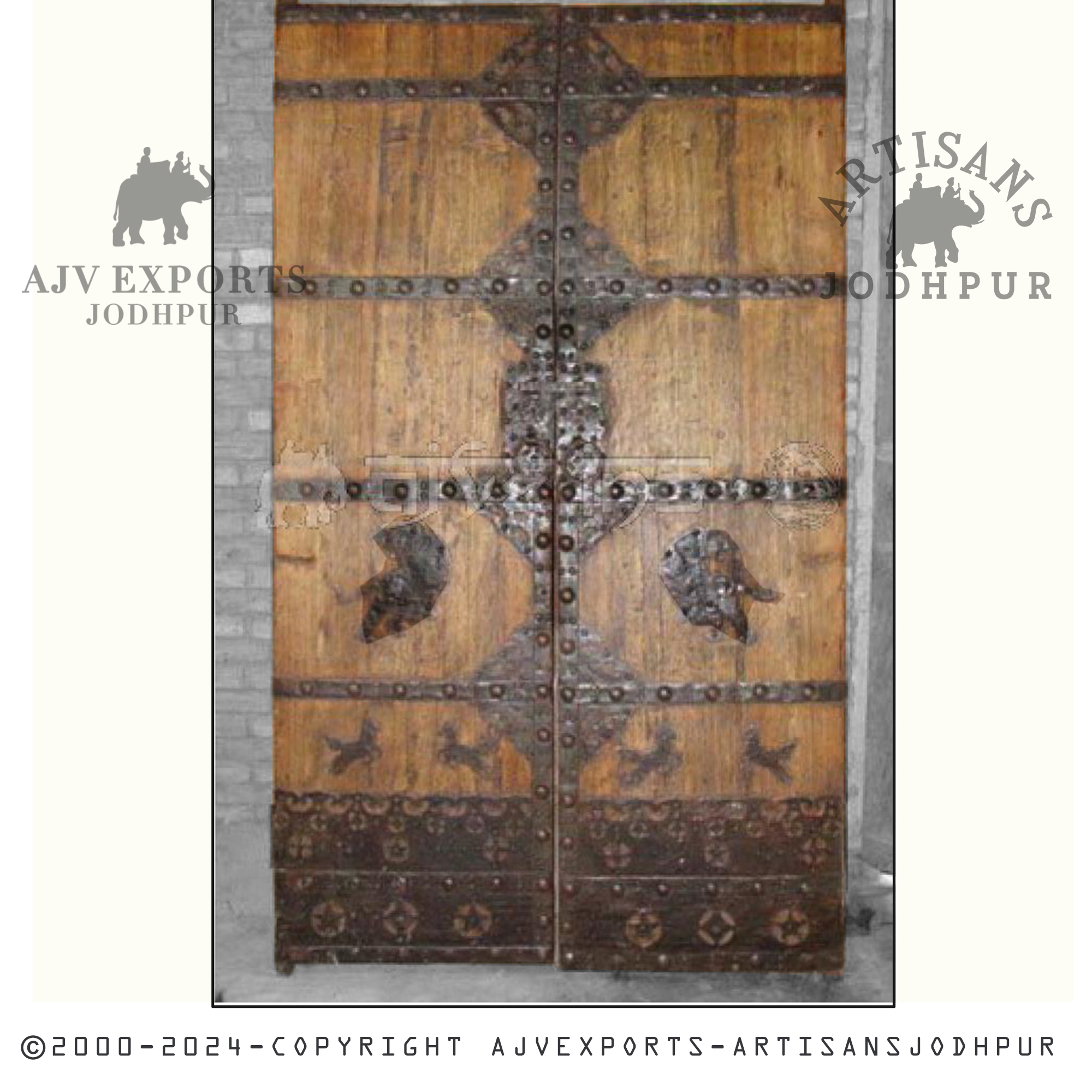 A handcrafted ornate wooden door featuring intricate designs and metal accents, showcasing superior craftsmanship from AJV Exports Jodhpur