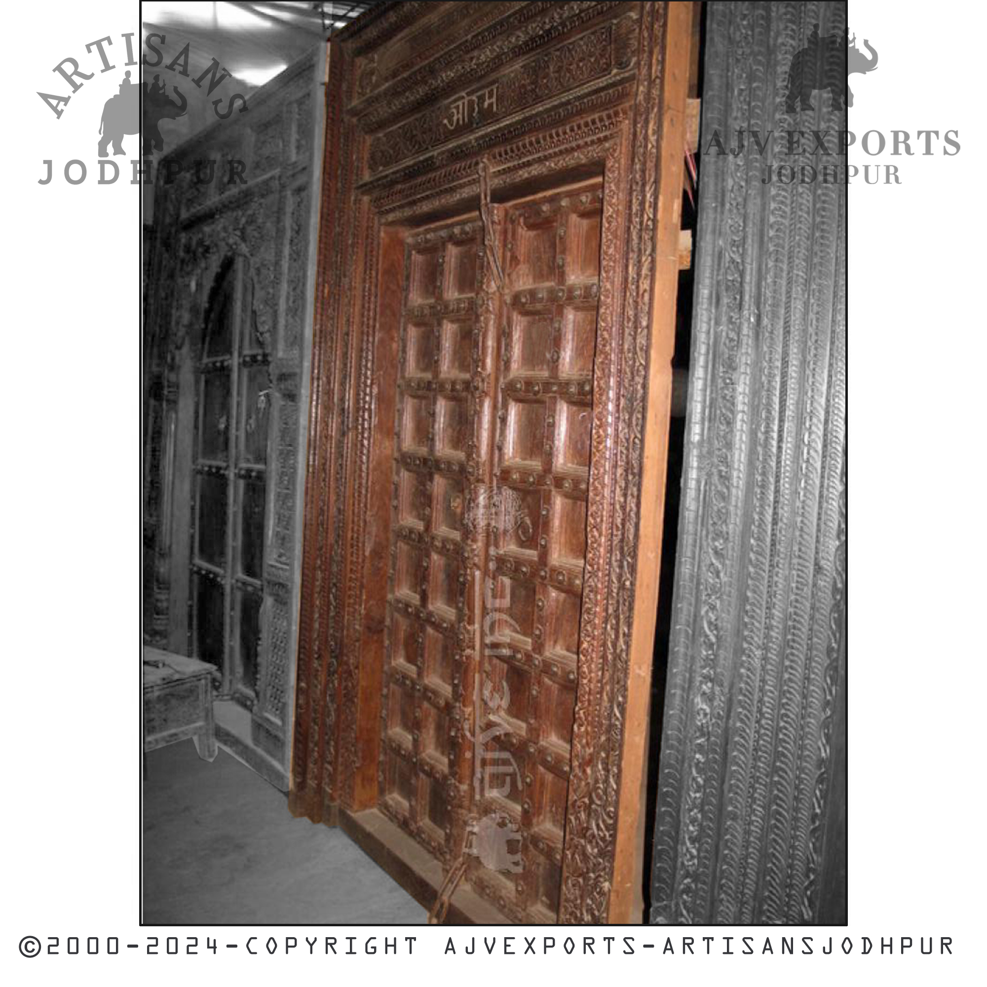 An intricate wooden door with geometric carvings, showcasing the craftsmanship of Jodhpur artisans.