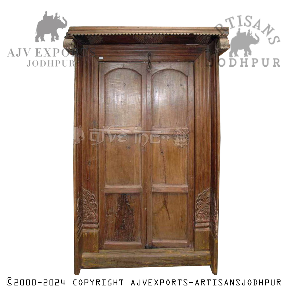 Handcrafted wooden door with intricate metal detailing, showcasing Jodhpur's artisan craftsmanship.