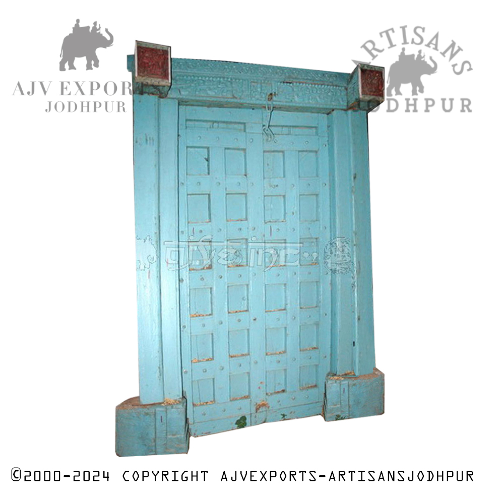 A bright blue wooden door with a textured surface and rustic finish, ideal for adding vibrant color and character to any entrance.
