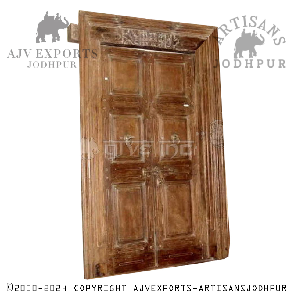 Aged wooden door with six panels and decorative metal handles