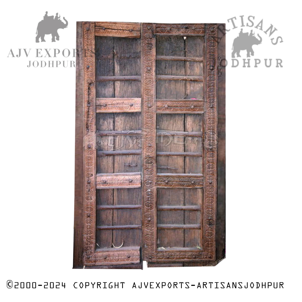 A beautifully carved wooden door with traditional Indian motifs and a rich natural wood finish.