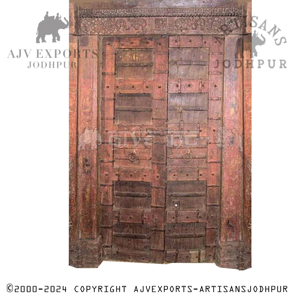 Rustic Indian door with deep cultural carvings and an aged patina.