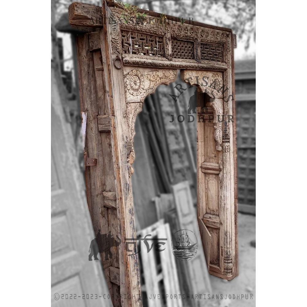 Rustic wooden door with green paint and iron handles