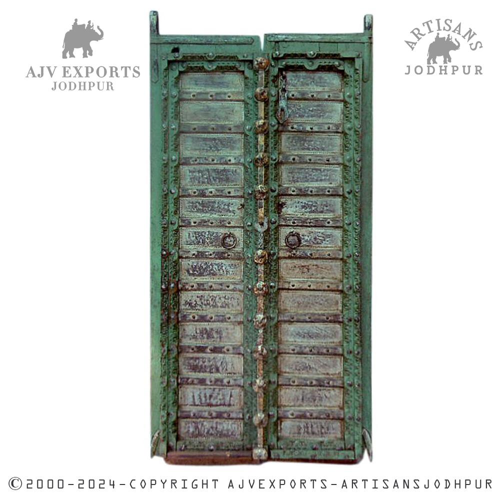Vintage wooden door with metal latches and timeworn patina