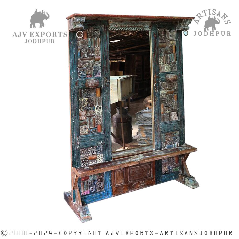 Vintage wooden mirror frame with intricate carvings and a rustic finish.