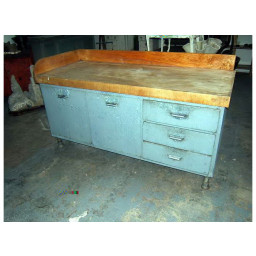 industrial rustic three drawer iron kitchen island with wooden top.