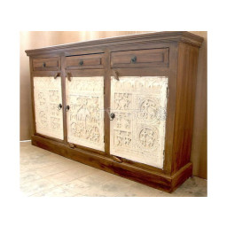 Wooden storage cabinet with tribal carving on the doors and three drawers