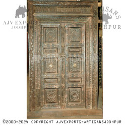 Intricately carved door with brass accents