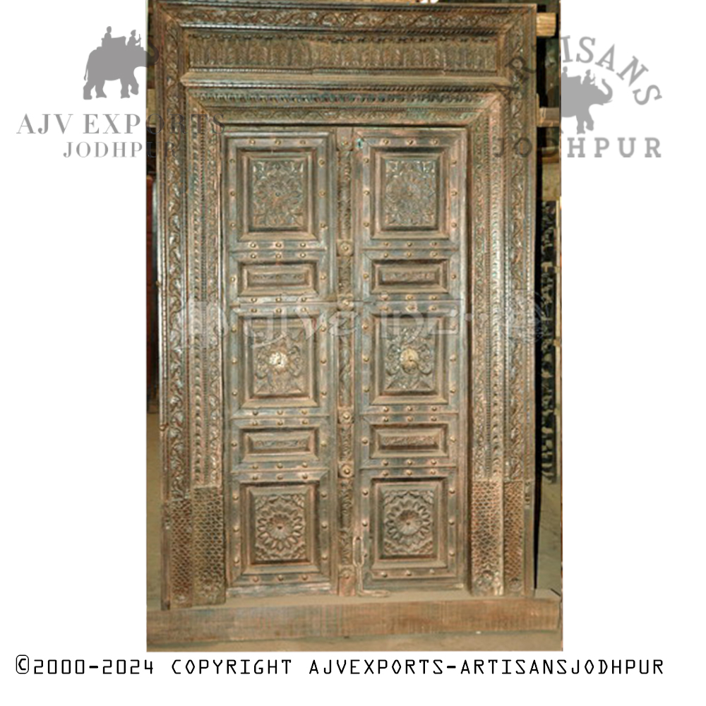 Carved wooden door with brass studs