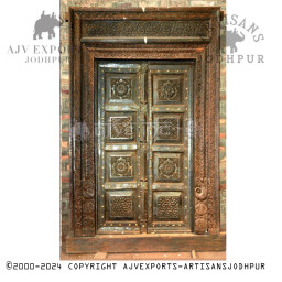 Wooden door with intricate green carvings