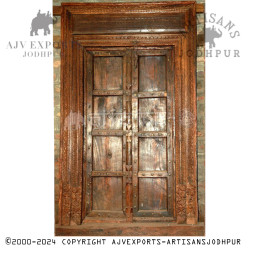 Wooden door with detailed carvings and rustic finish