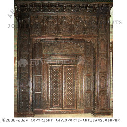 Wooden door with detailed carvings and arch