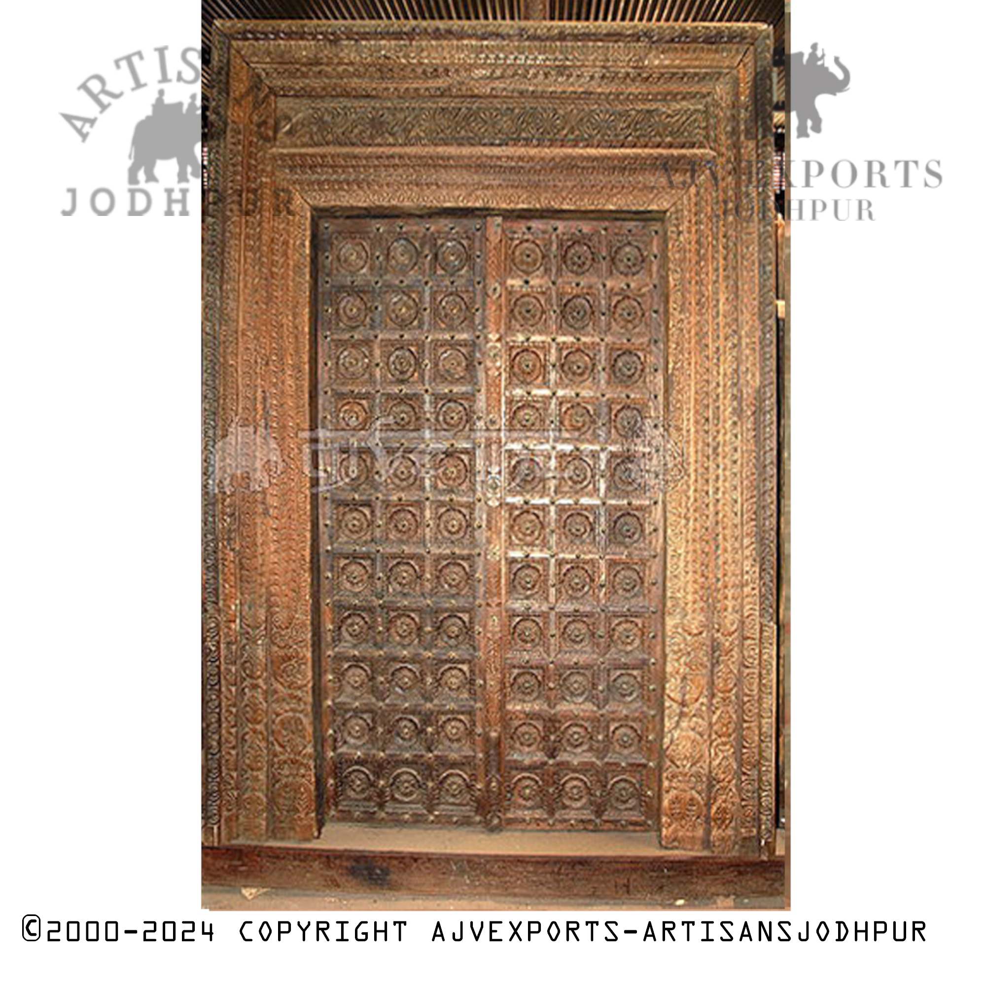 Wooden door with intricate brass and patina