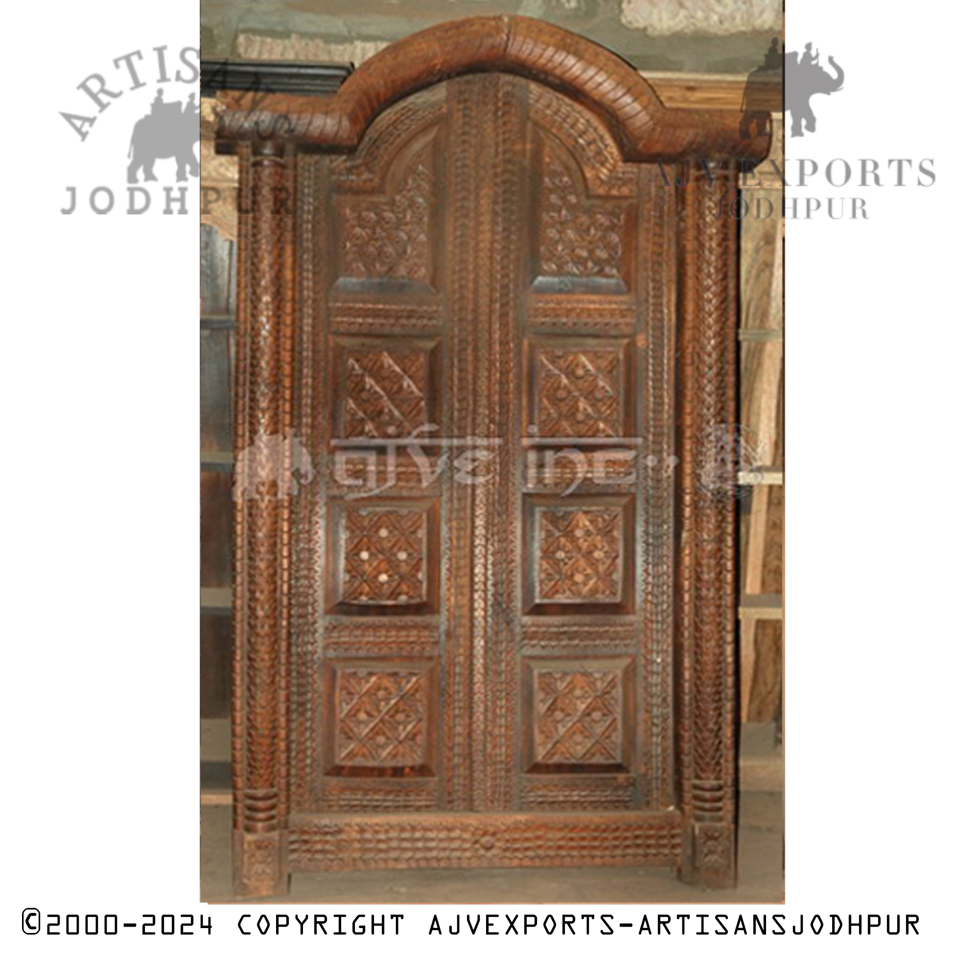 Wooden door with detailed carvings and arch