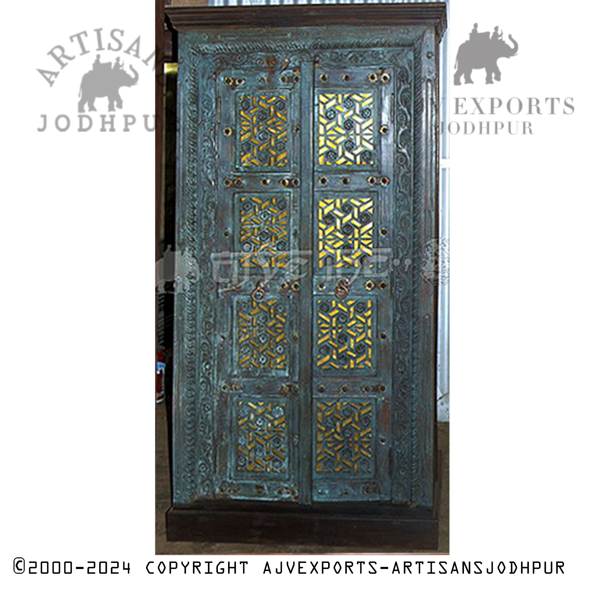 Wooden door with ornate carvings and verdigris patina