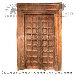 Wooden door with brass details and intricate carvings