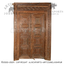 Wooden door with rich patina and detailed carvings