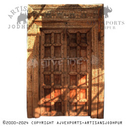 Wooden door with intricate carvings and brass details