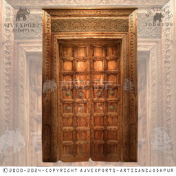 Wooden door with brass accents and geometric carvings