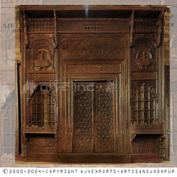 Wooden door with intricate carvings and brass details