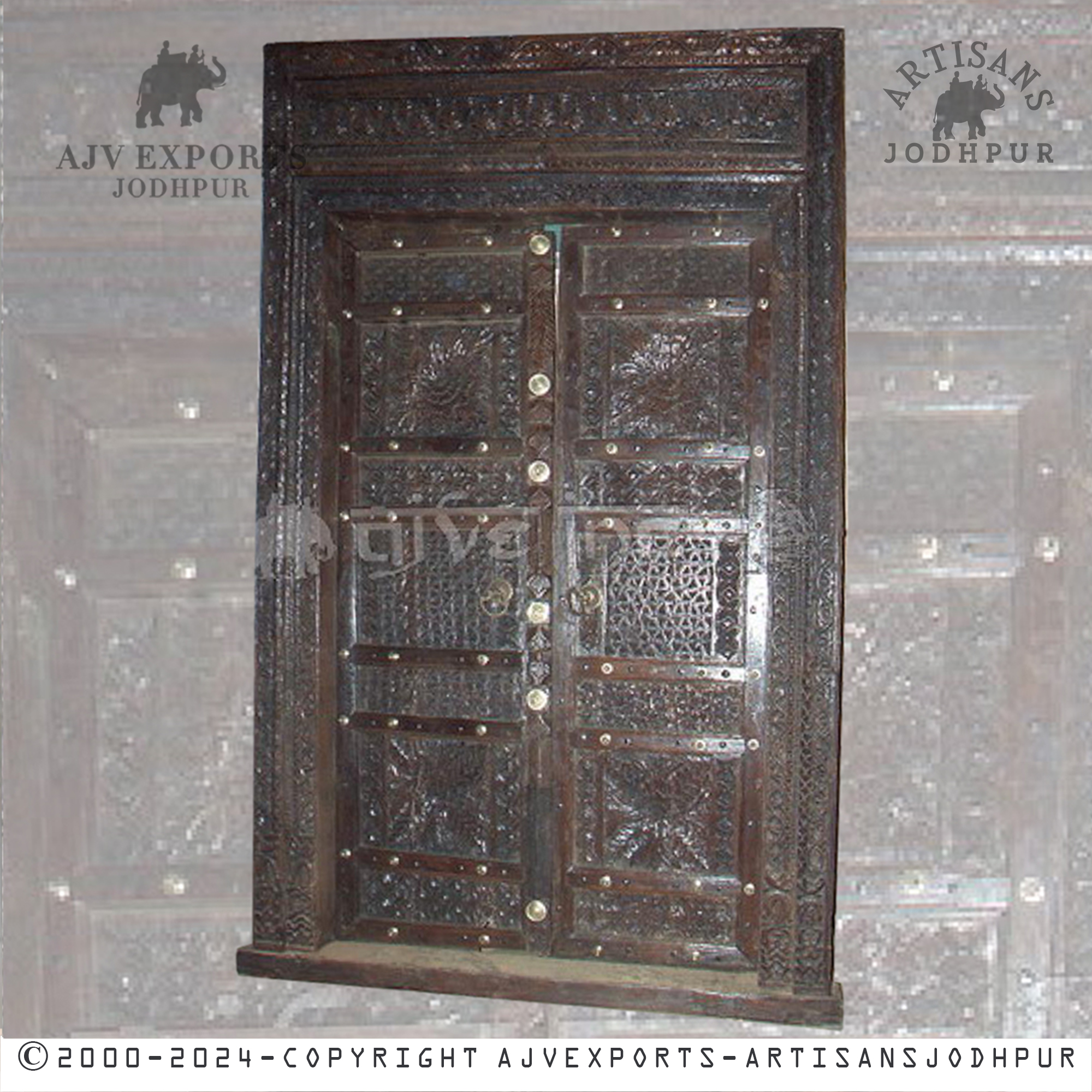 Antique wooden door with intricate ornate carvings and an elegant design, highlighting traditional craftsmanship.