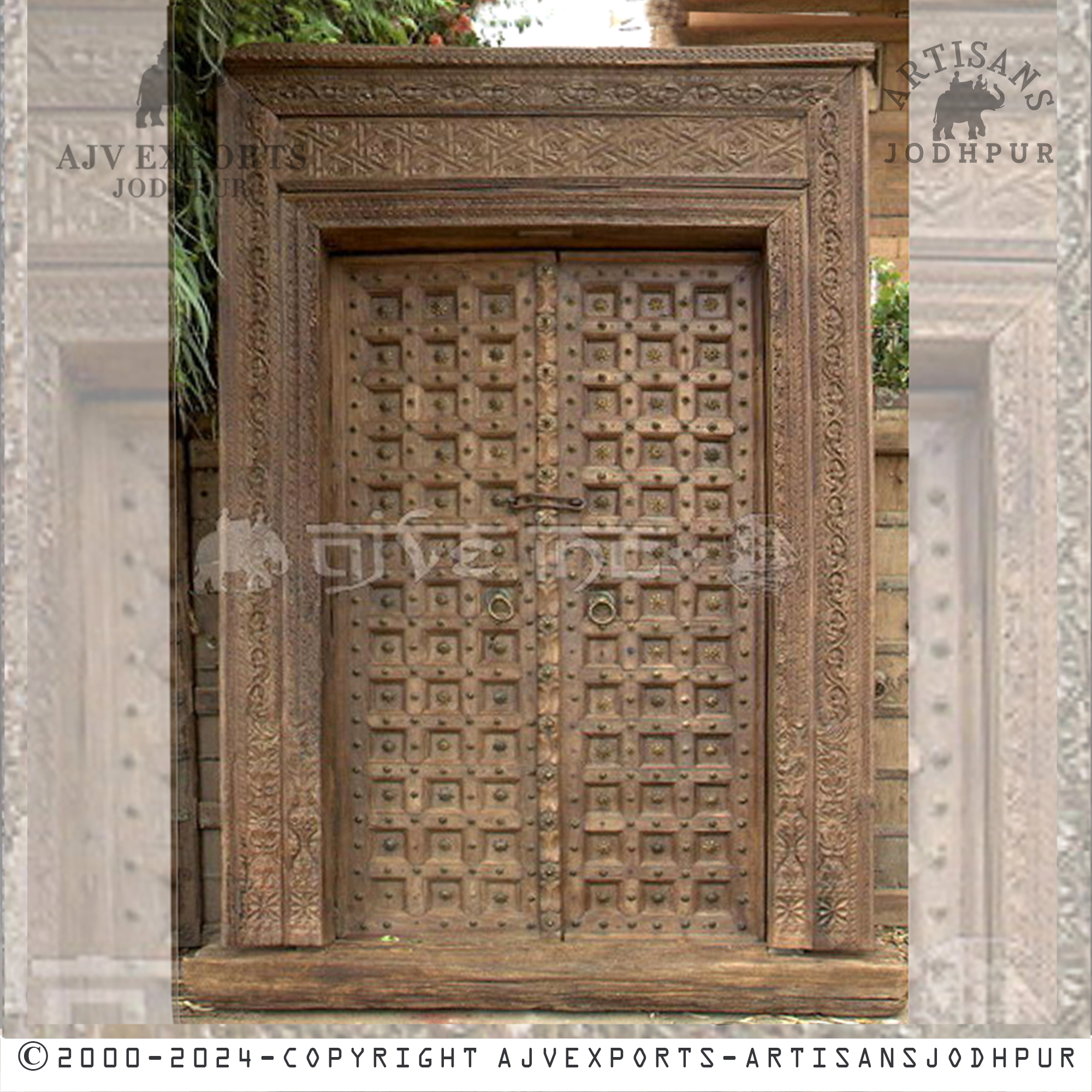 Rustic wooden door with vintage carvings and a weathered finish, perfect for enhancing historic decor.
