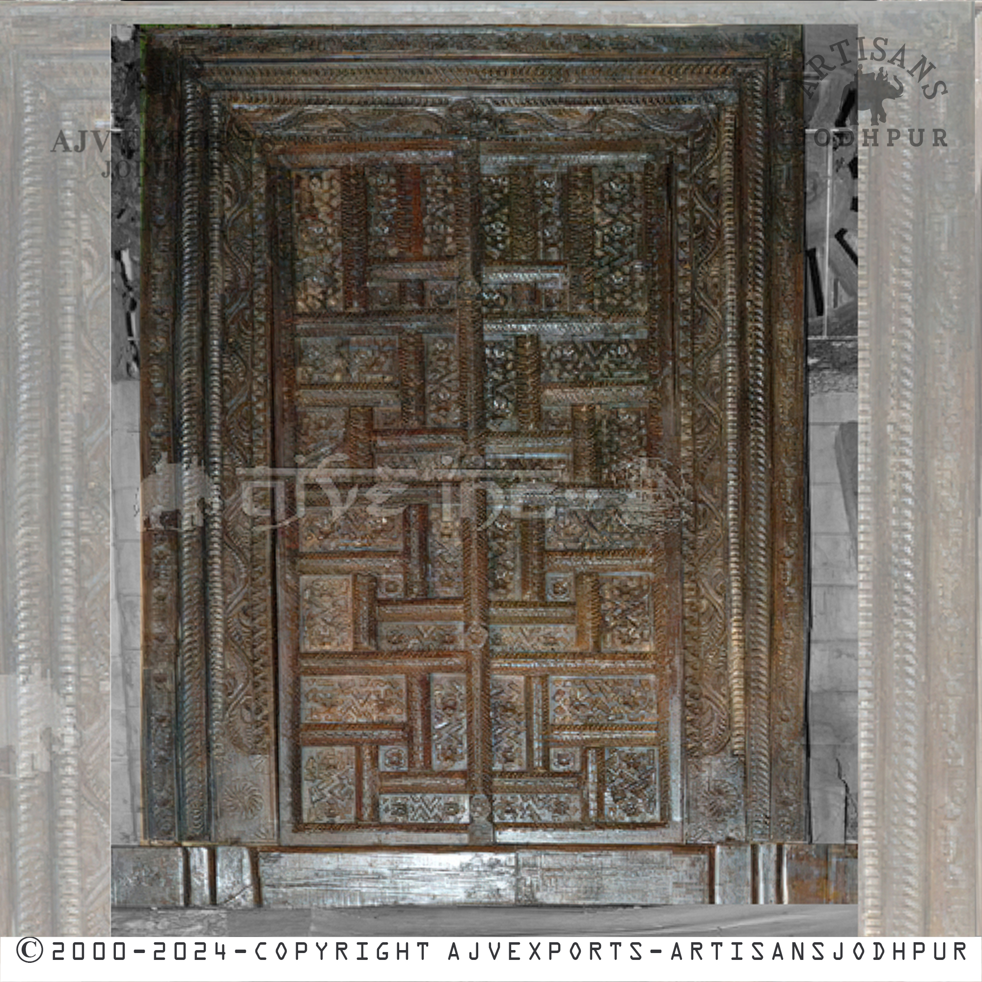 An ornate wooden door with deep carvings of floral and geometric designs, crafted by artisans from Jodhpur, India.
