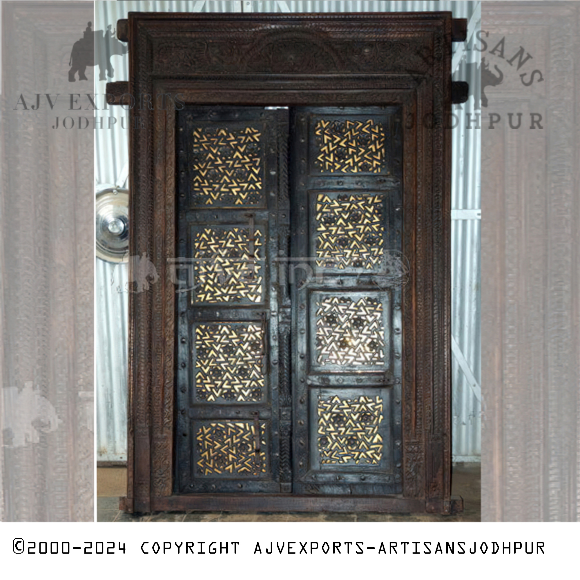 A traditional wooden door adorned with ornamental ironwork, crafted in Jodhpur, India.