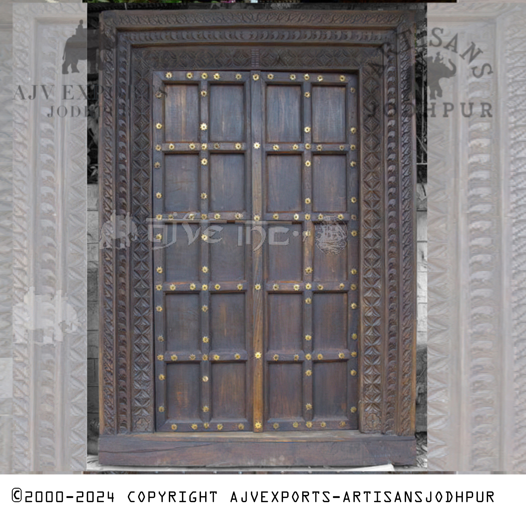 A traditional wooden door from Jodhpur, featuring dark wood with bright metal bolts across the panels, combining strength with traditional design.