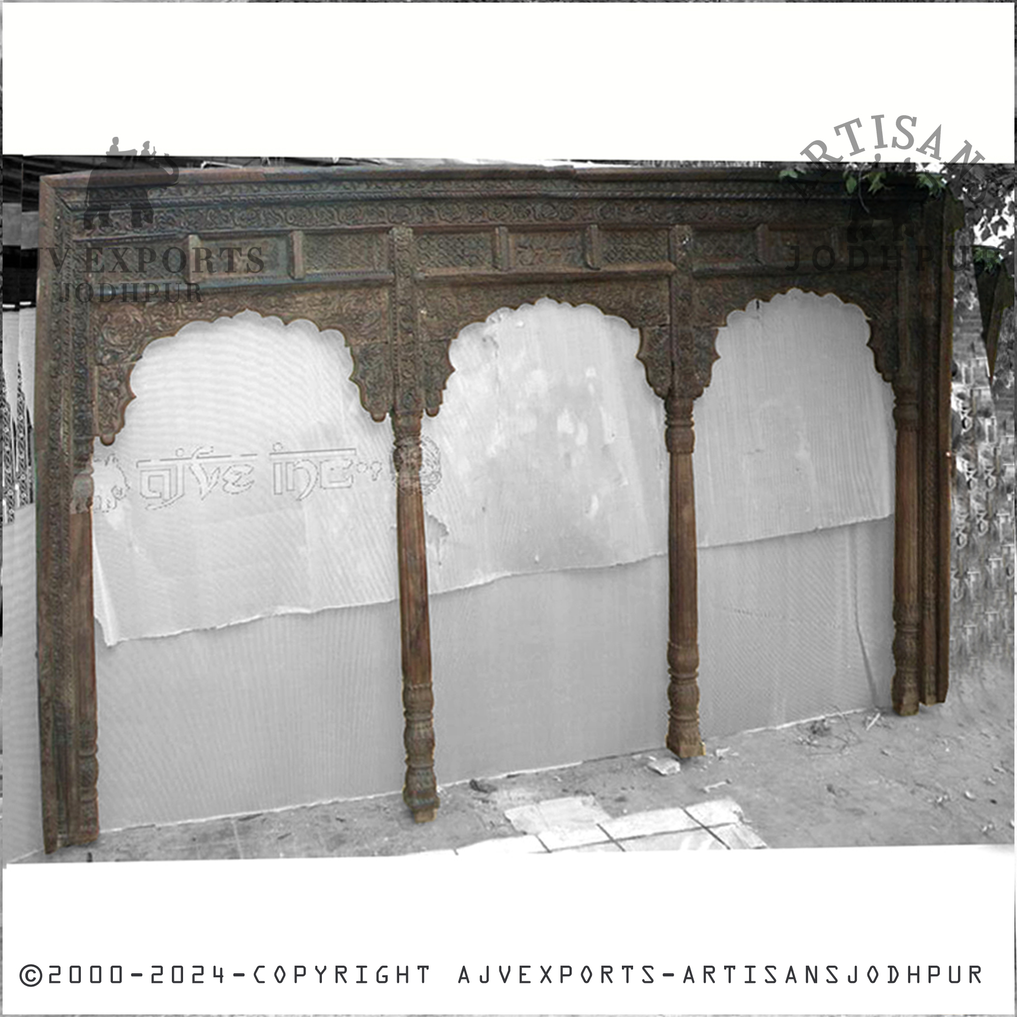 A traditional archway from Jodhpur with sturdy wooden pillars and a beautifully carved canopy, featuring deep traditional patterns.