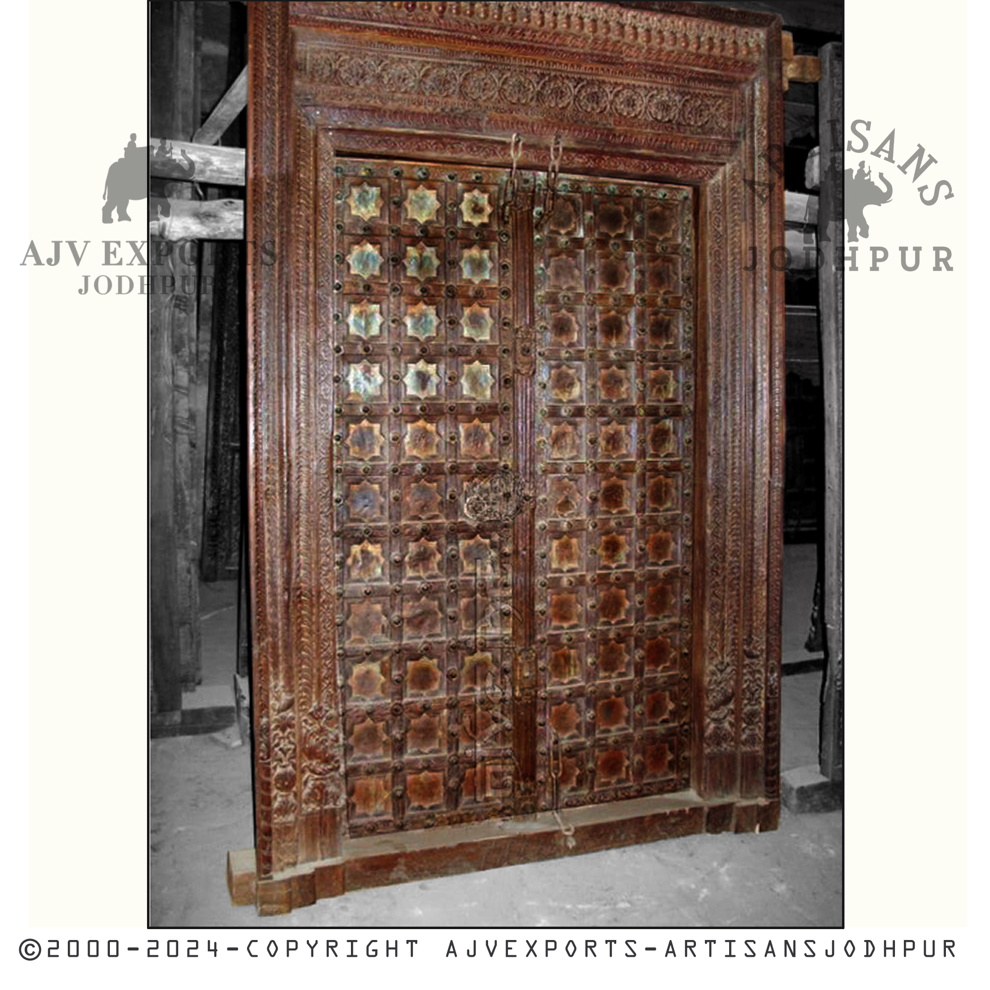 An antique wooden door featuring beautifully carved star motifs, showcasing vintage charm from AJV Exports Jodhpur