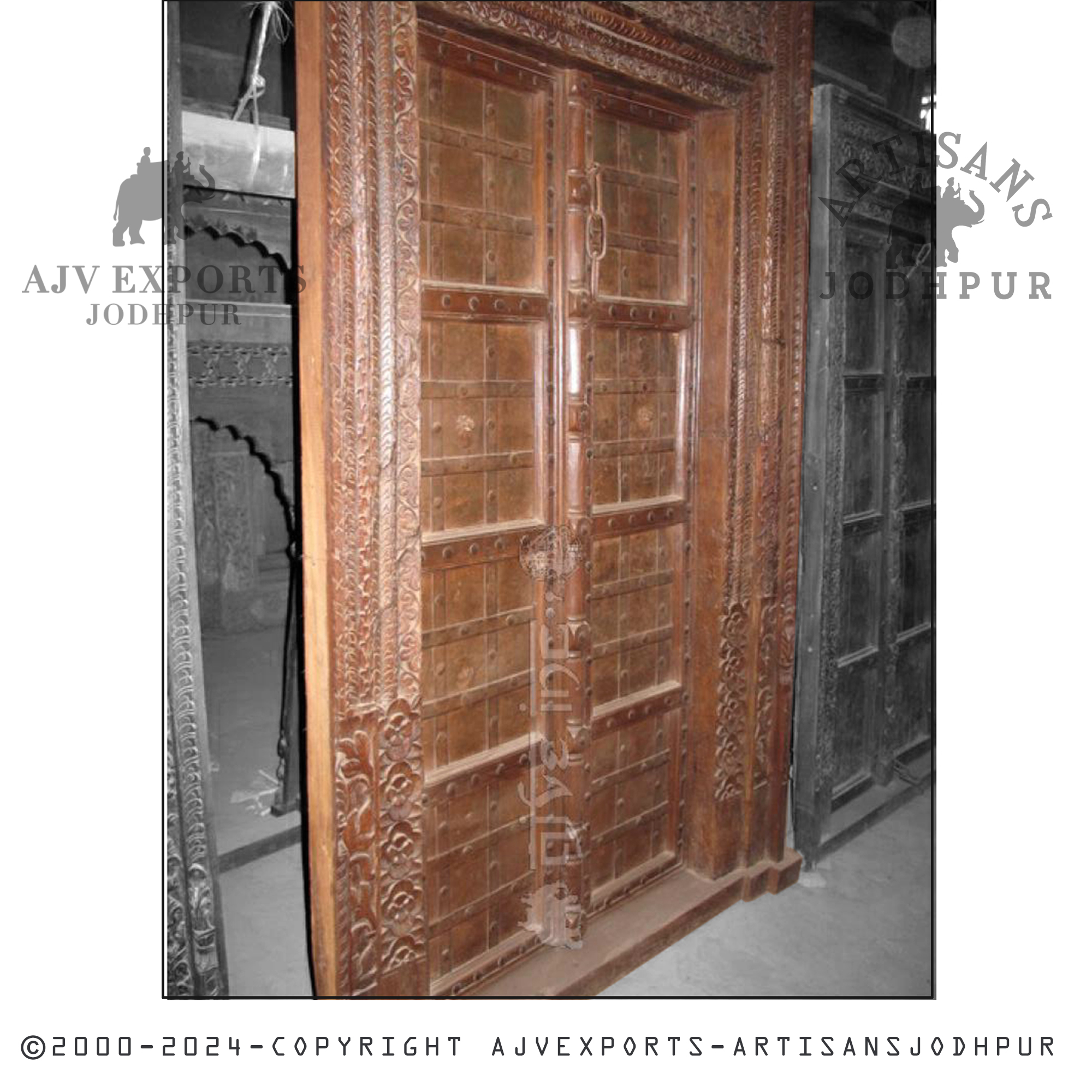 A grand wooden entrance featuring exquisite ornate carvings, adding a luxurious touch to any property from AJV Exports Jodhpur