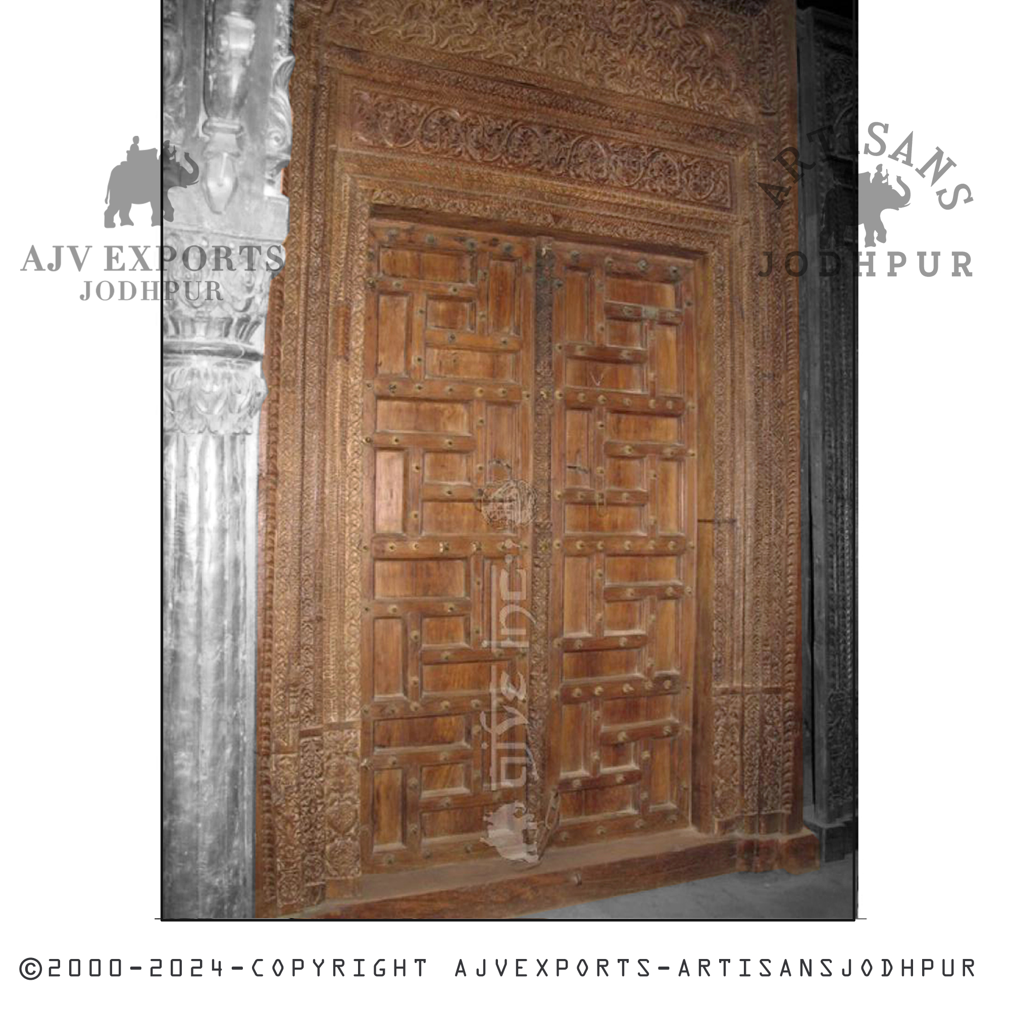 An antique carved wooden panel door showcasing intricate designs and vintage elegance from AJV Exports Jodhpur