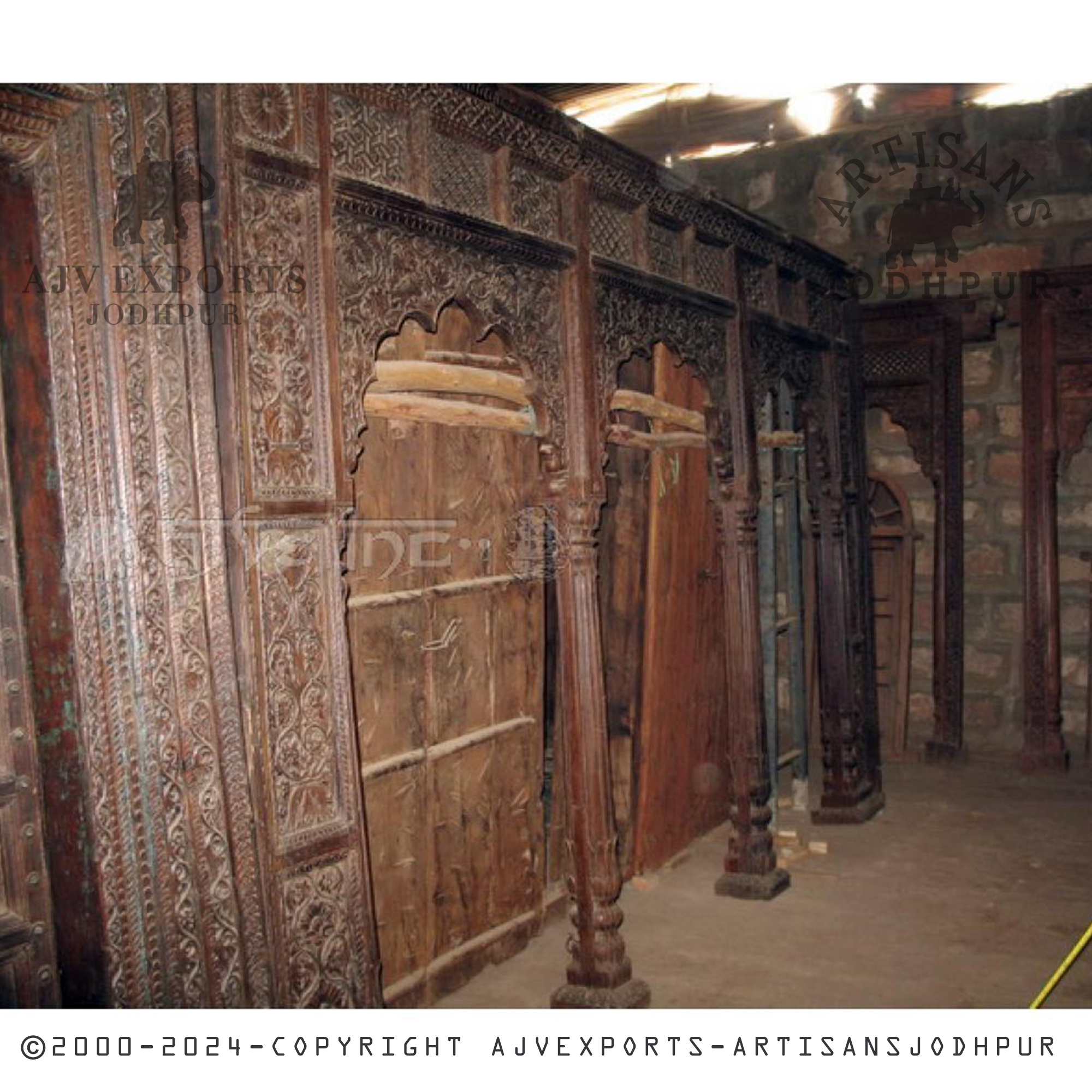 A traditional wooden door featuring decorative carvings, adding a touch of elegance to any space from AJV Exports Jodhpur