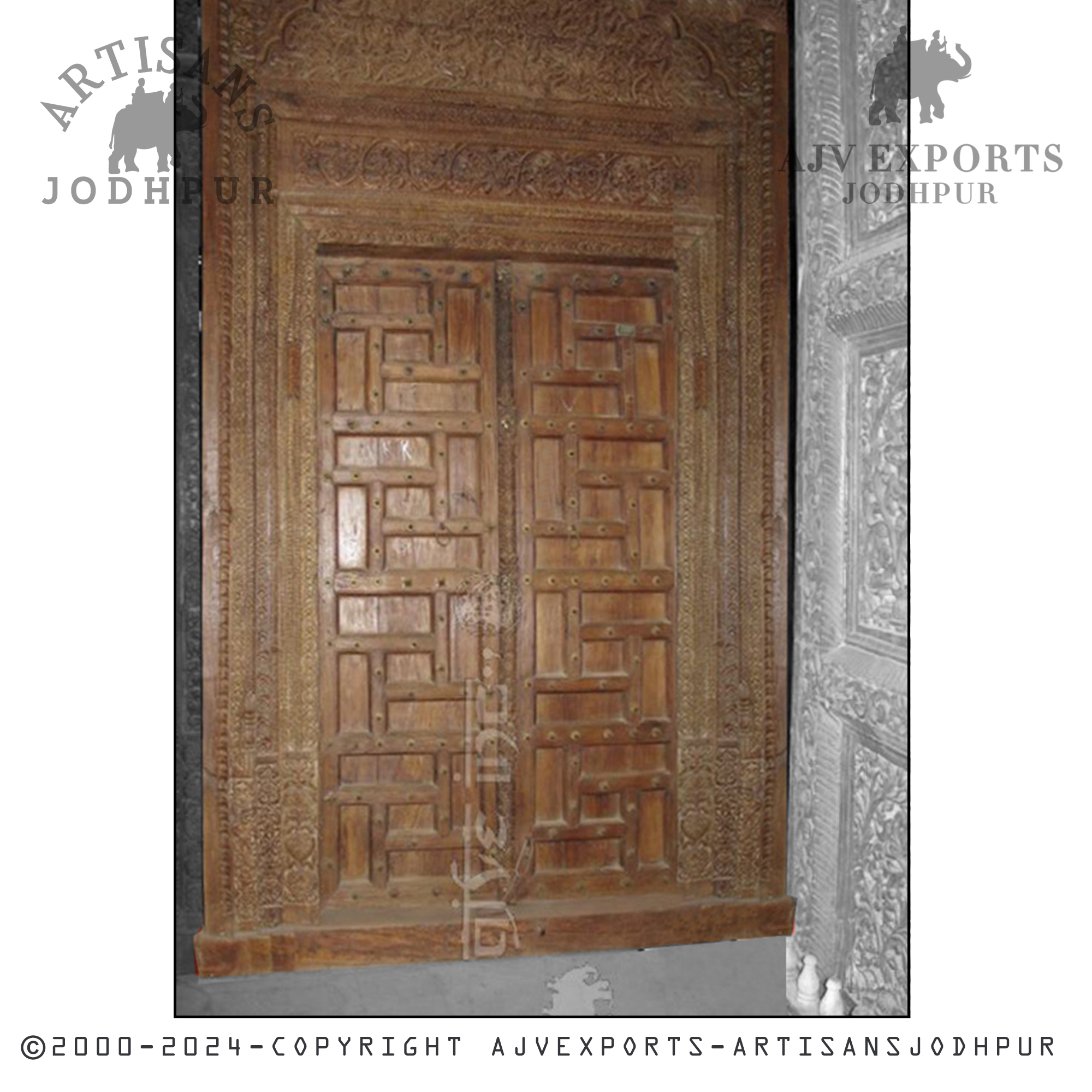 An antique wooden door with traditional carvings, reflecting the rich cultural heritage of Jodhpur.