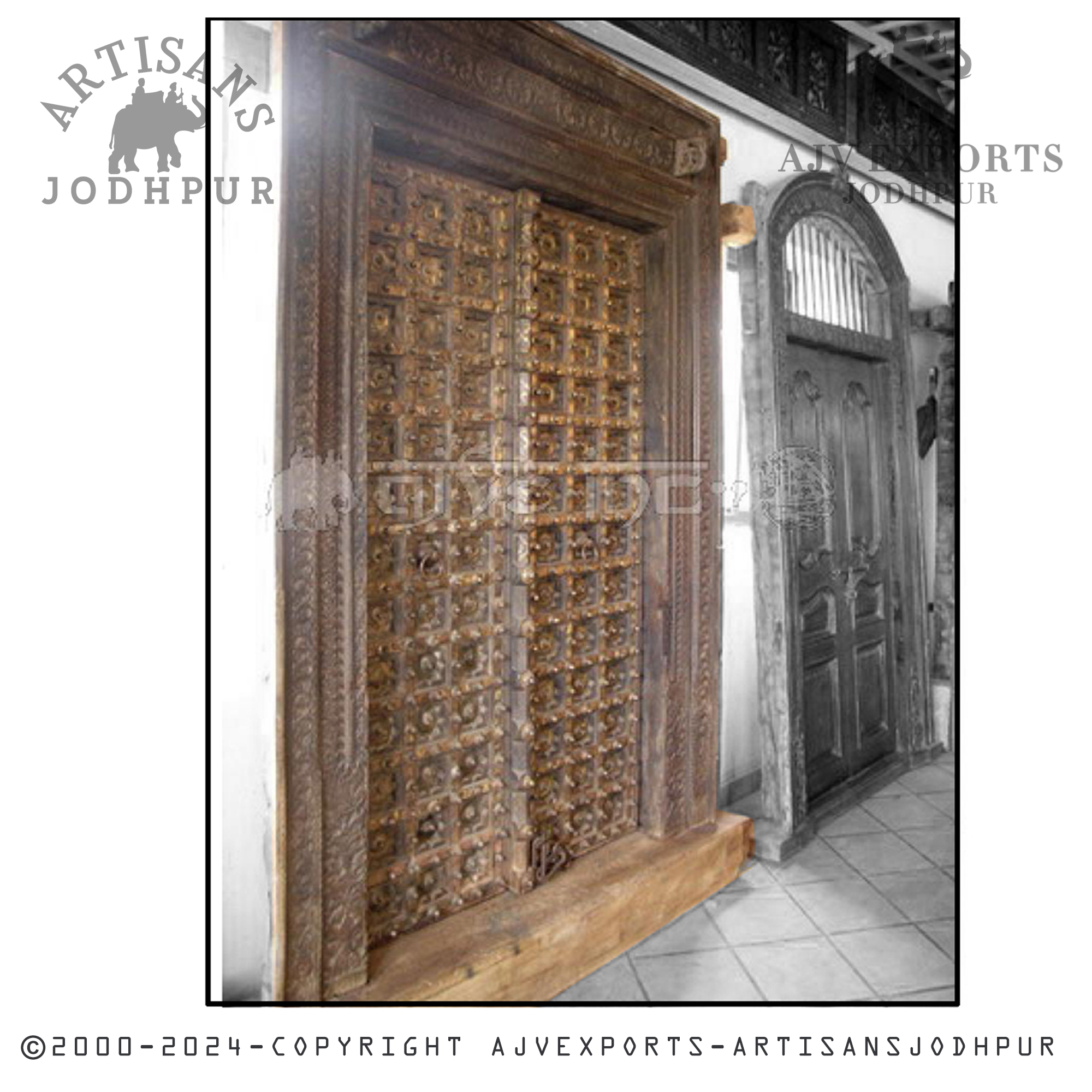 An antique wooden door with intricate carvings and a traditional design, highlighting Jodhpur's skilled craftsmanship.