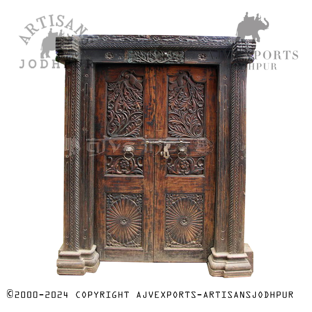 An elaborately carved wooden door with floral and geometric patterns, highlighting the craftsmanship of Jodhpur artisans.