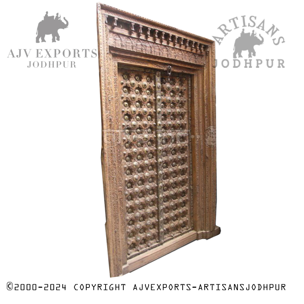 An intricately carved wooden door with detailed patterns and traditional designs, highlighting the craftsmanship of Jodhpur artisans.