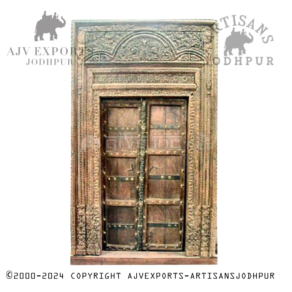 A traditional carved wooden doorway with detailed patterns and ornate designs, showcasing the craftsmanship of Jodhpur artisans.