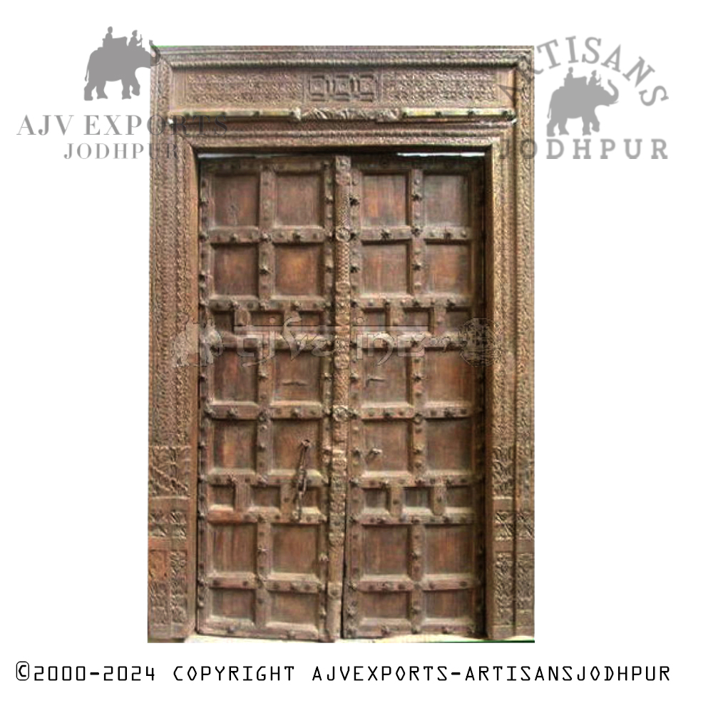 An elaborately carved wooden door with detailed patterns and traditional designs, highlighting Jodhpur's craftsmanship.