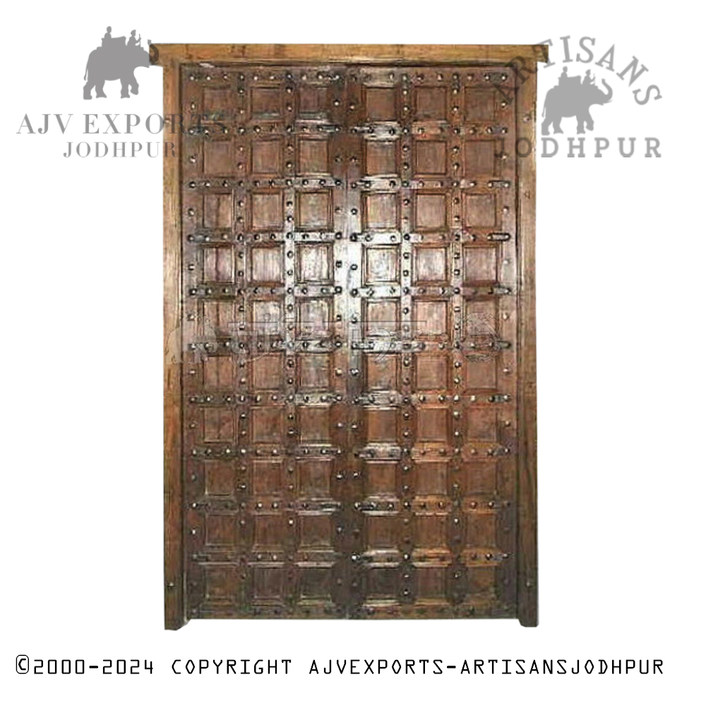 An intricately carved antique wooden door with geometric patterns and traditional designs, highlighting Jodhpur's craftsmanship.