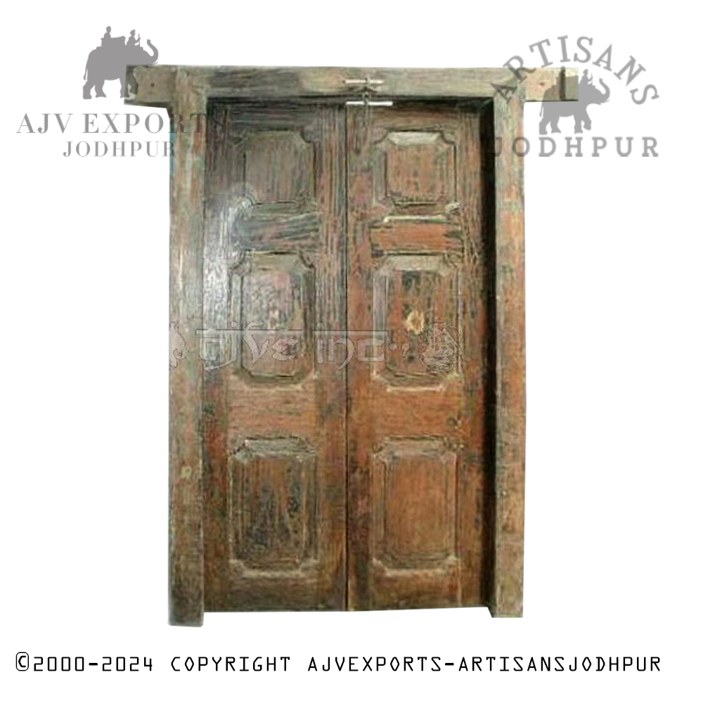 An antique wooden door with ornate wooden panel and traditional design elements, showcasing Jodhpur's craftsmanship.