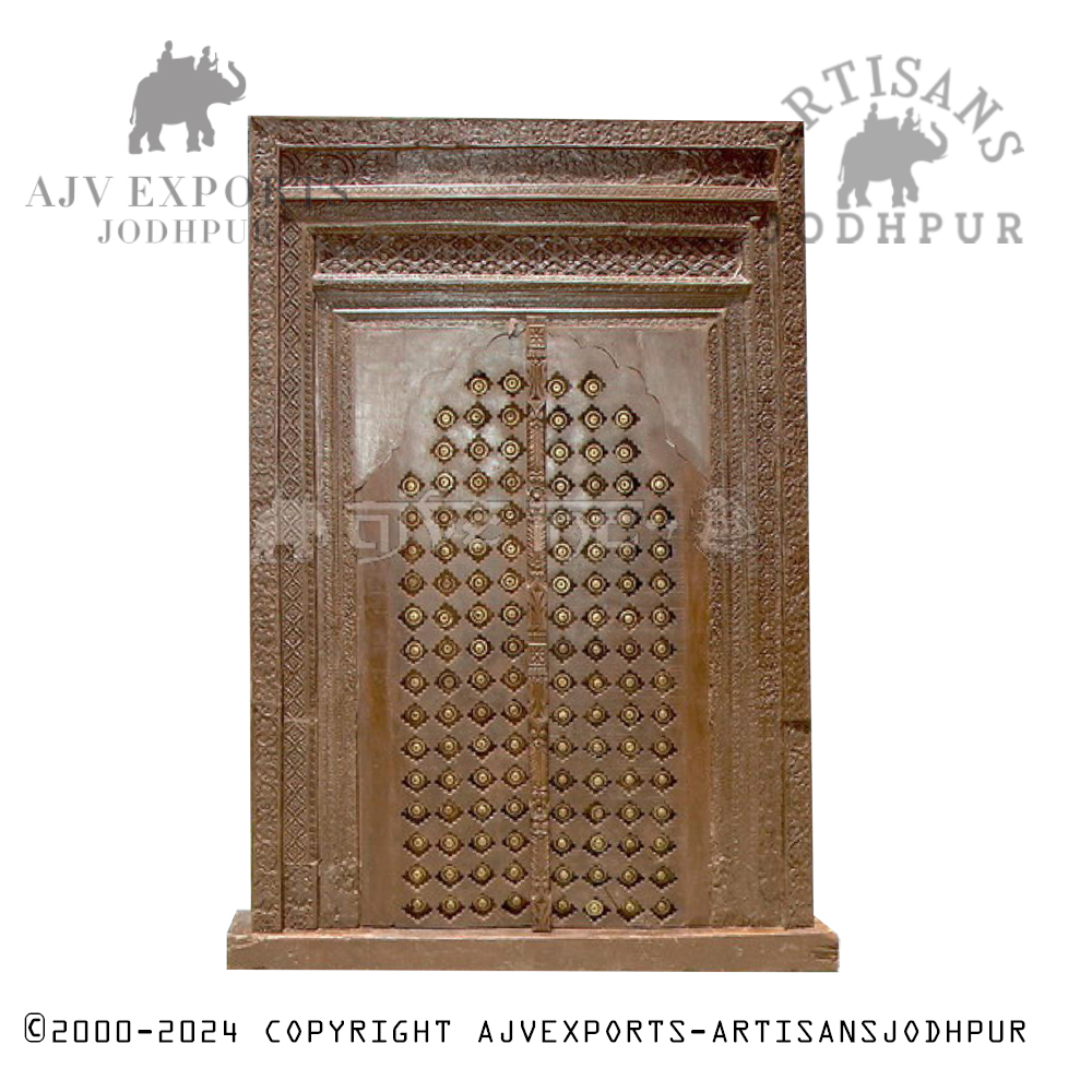 An intricately carved wooden door with detailed patterns and traditional designs, highlighting Jodhpur's craftsmanship.