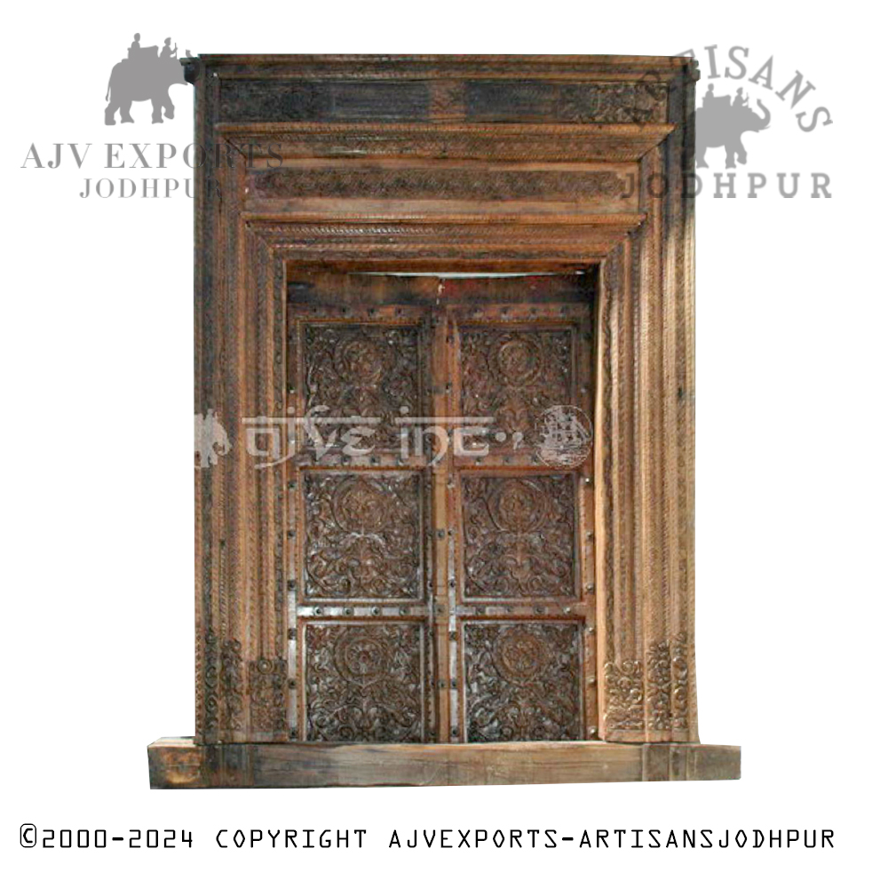 An ornate antique wooden door with traditional carvings and detailed patterns, showcasing Jodhpur's craftsmanship.
