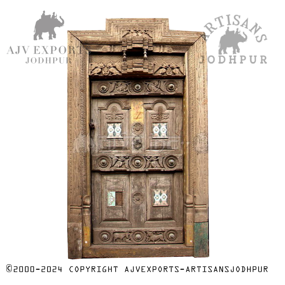 A handcrafted wooden door with brass embellishments and intricate patterns