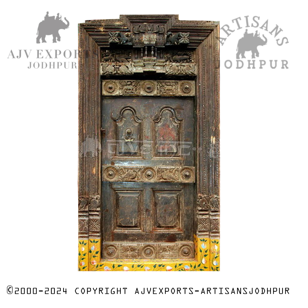A traditional wooden door with brass detailing and intricate carvings.