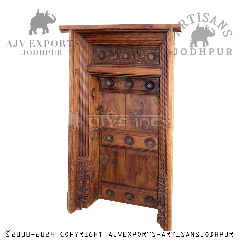 Traditional wooden door with circular metal accents and a decorative frame, exuding old-world charm.